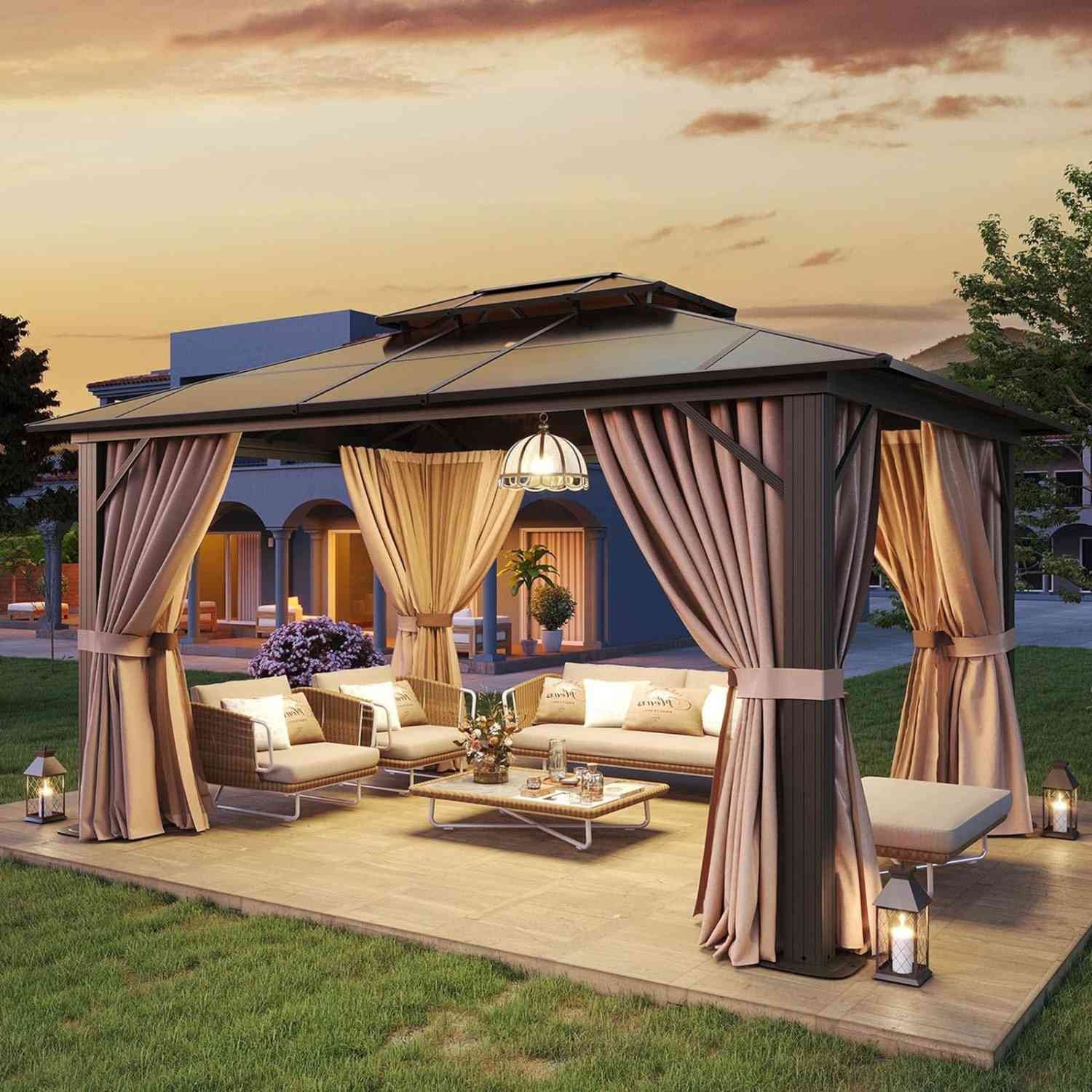 A hard top gazebo in a backyard at sunset