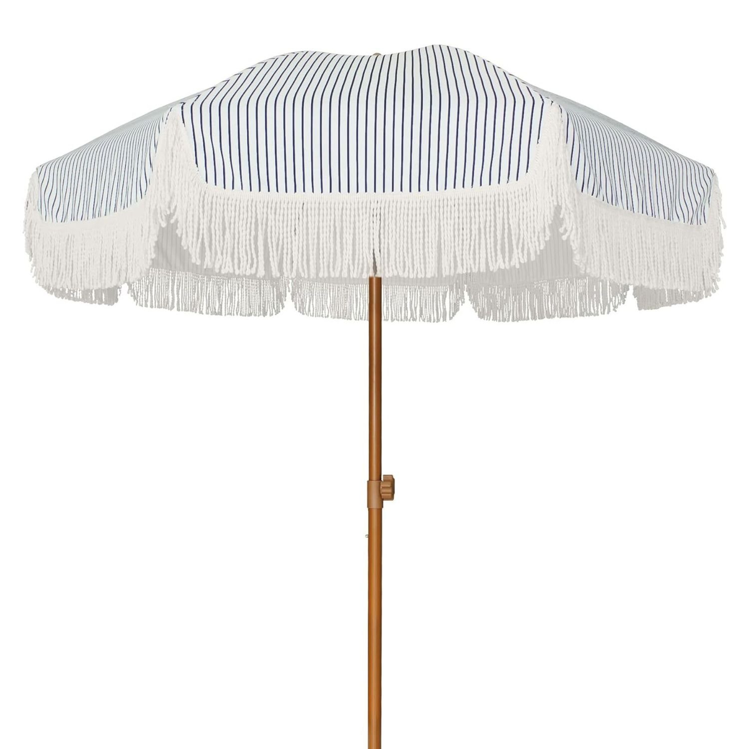 A blue and white striped umbrella with white tassels