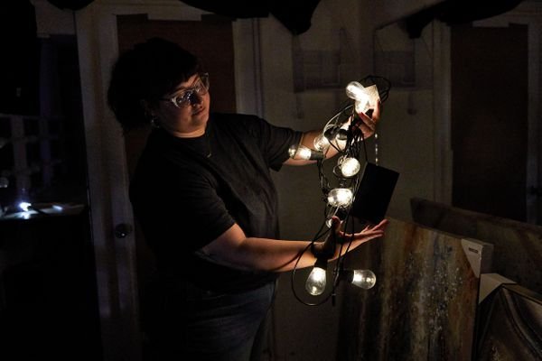 Person holding Brightech Ambiance Pro Solar Non-Hanging String Lights with two hands 