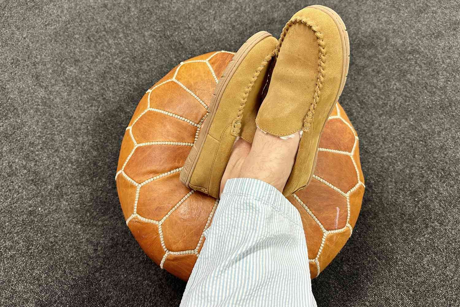 A person wearing the Lands' End Men's Suede Leather Moccasin Slipper