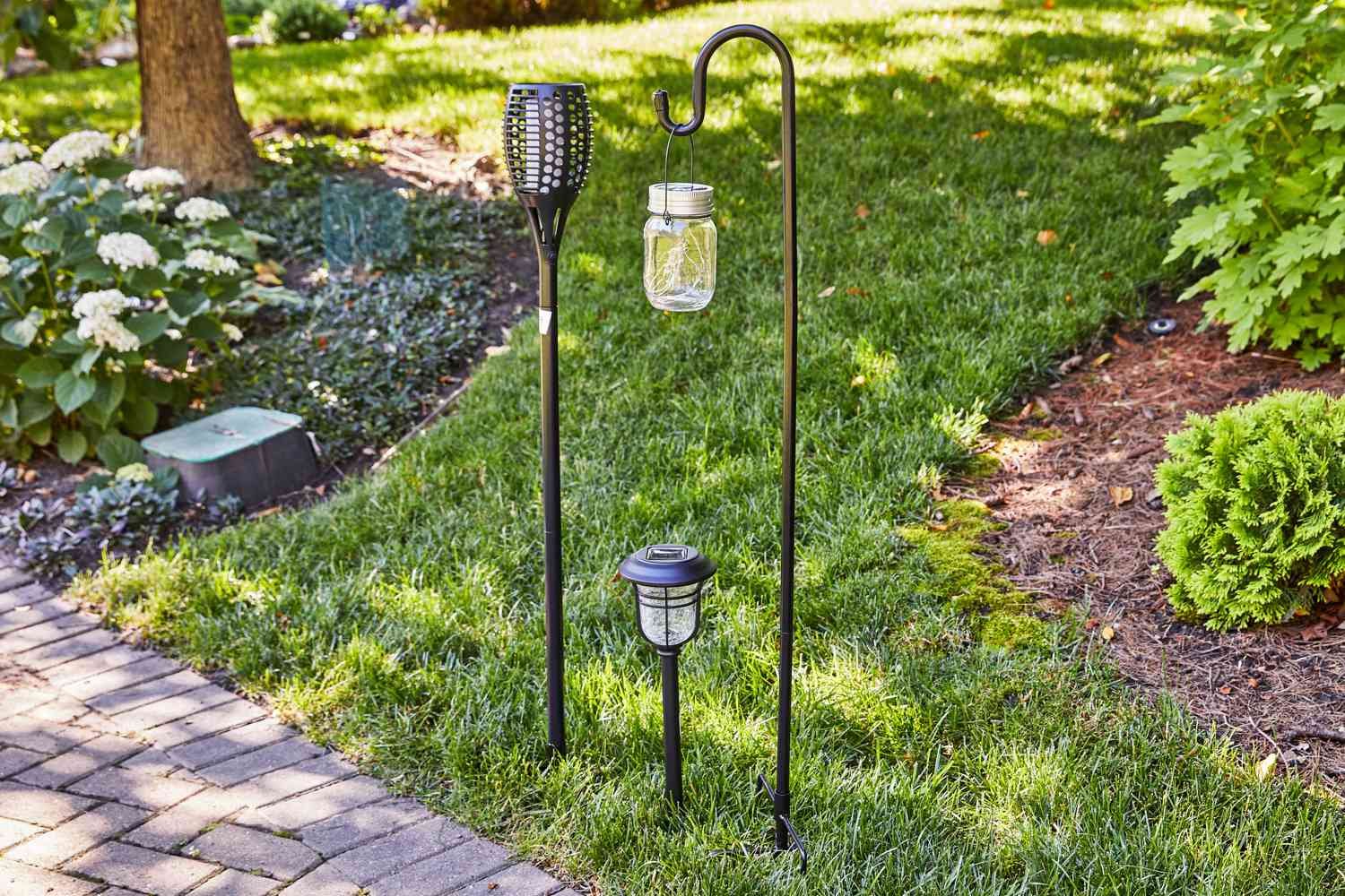 A variety of Outdoor Solar Lights are displayed outside on the grass