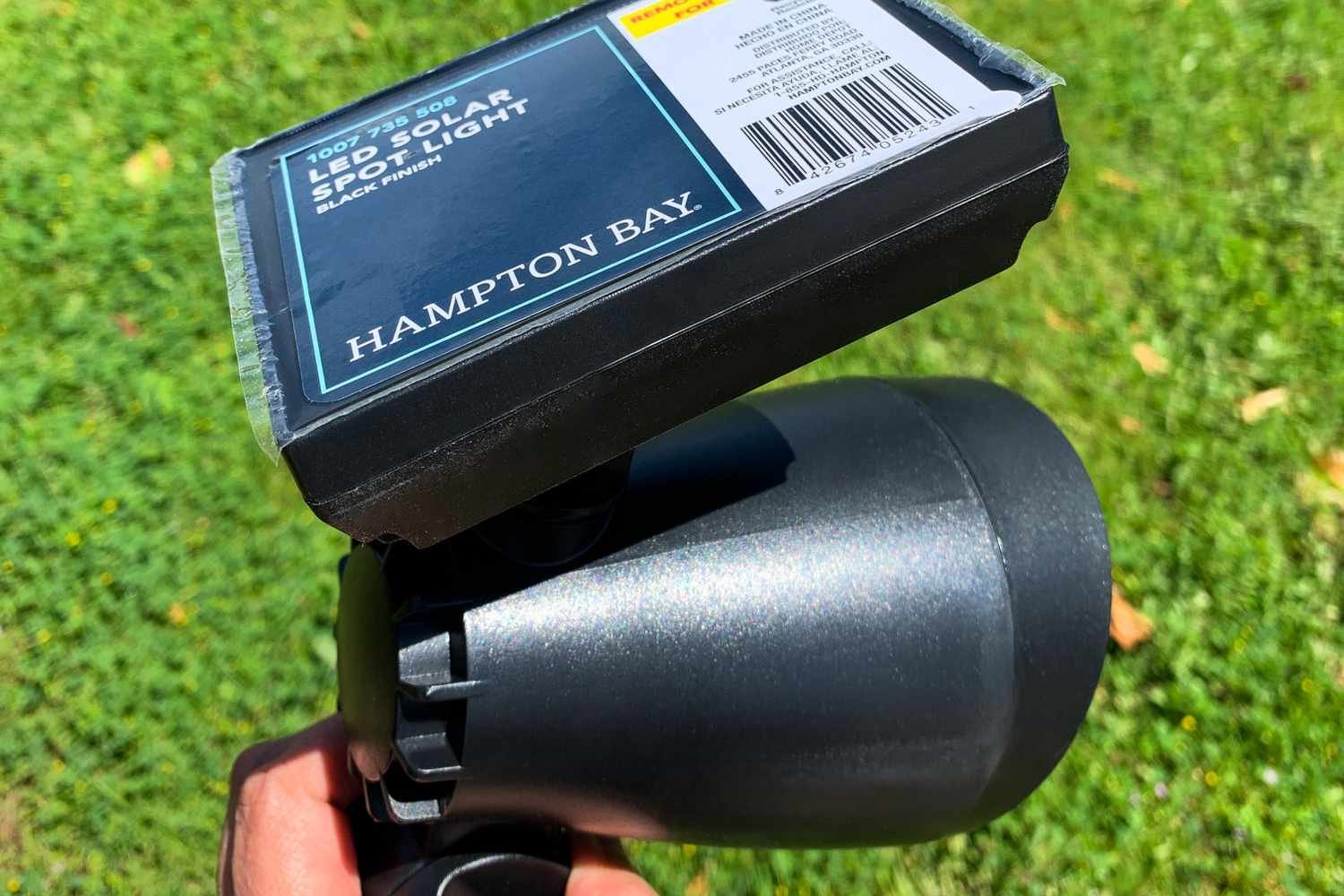 The Hampton Bay LED Outdoor Solar Spotlight with the sticker on