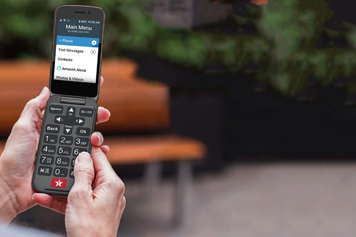 A person holds a Jitterbug flip phone.