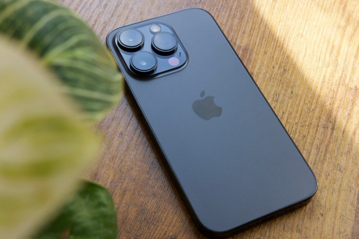 A black iPhone 14 Pro lying on a table.