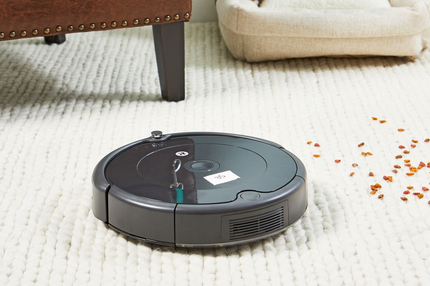 iRobot Roomba 694 Robot Vacuum cleaning dog food from white carpet 