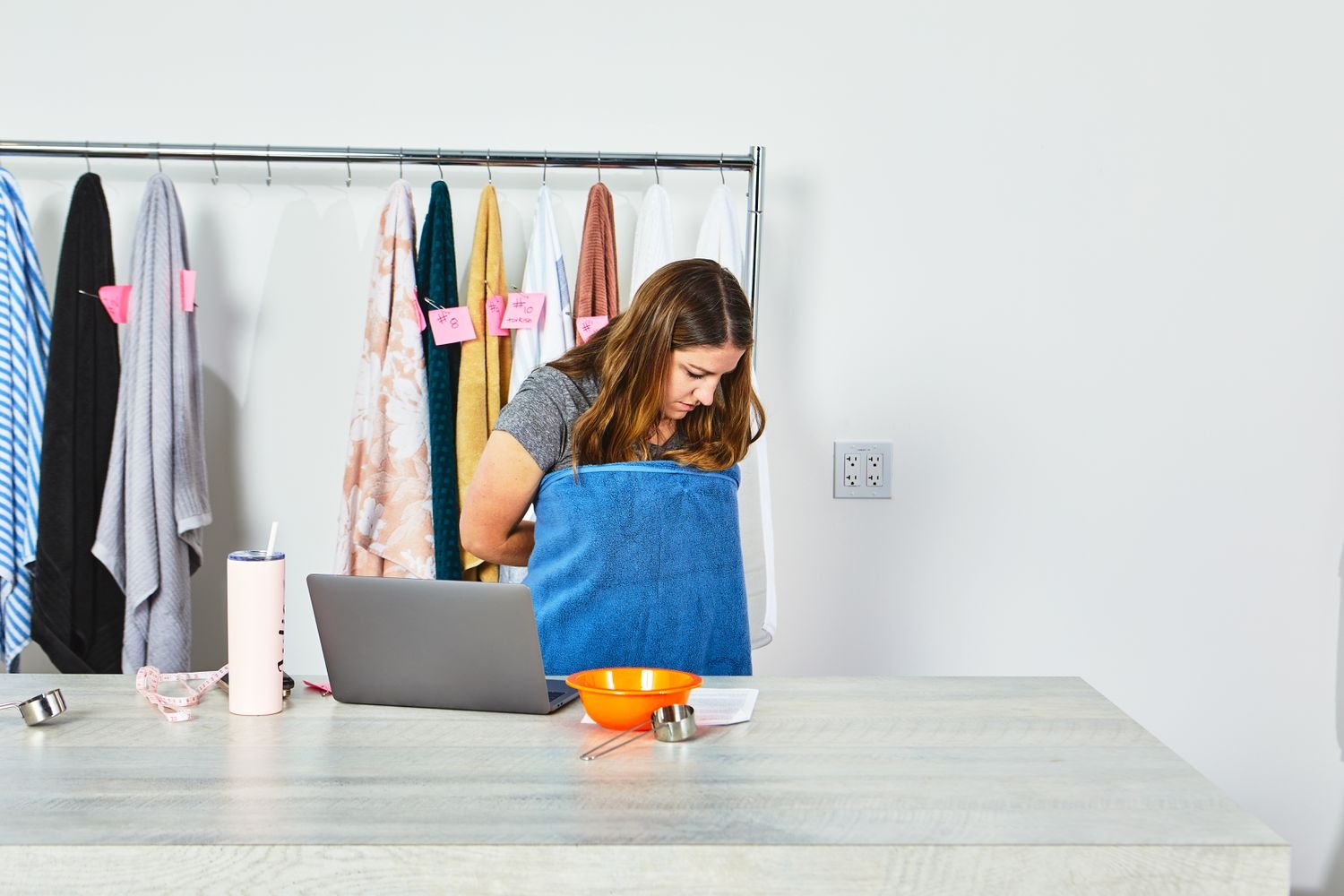 Woman wrapping Frontgate Resort Collection Bath Towel around her body with clothes on