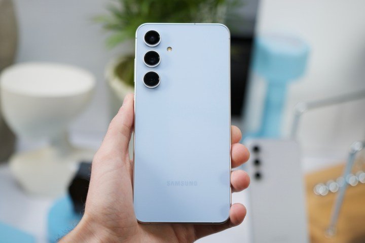 Someone holding the Samsung Galaxy S24 FE, showing the back of the phone.