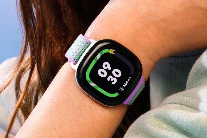 A photo of a kid wearing a Fitbit Ace LTE.