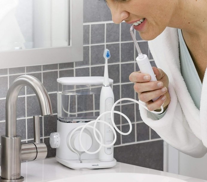 Waterpik Aquarius Water Flosser Professional being used in bathroom