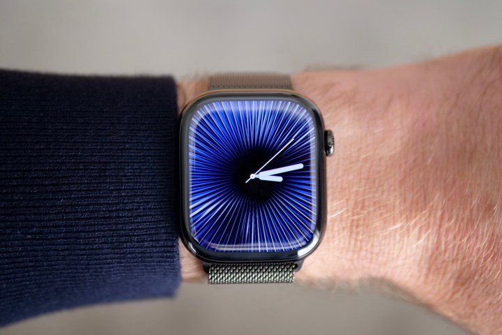 A person wearing the Apple Watch Series 10 in titanium with the Reflections watch face.