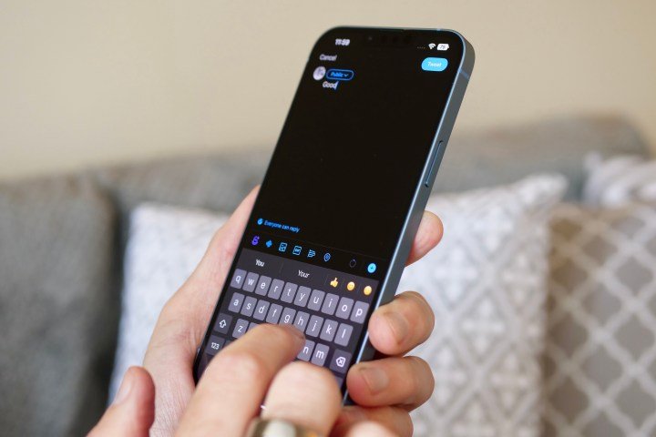 The Apple iPhone SE (2022) being held in a mans hand.