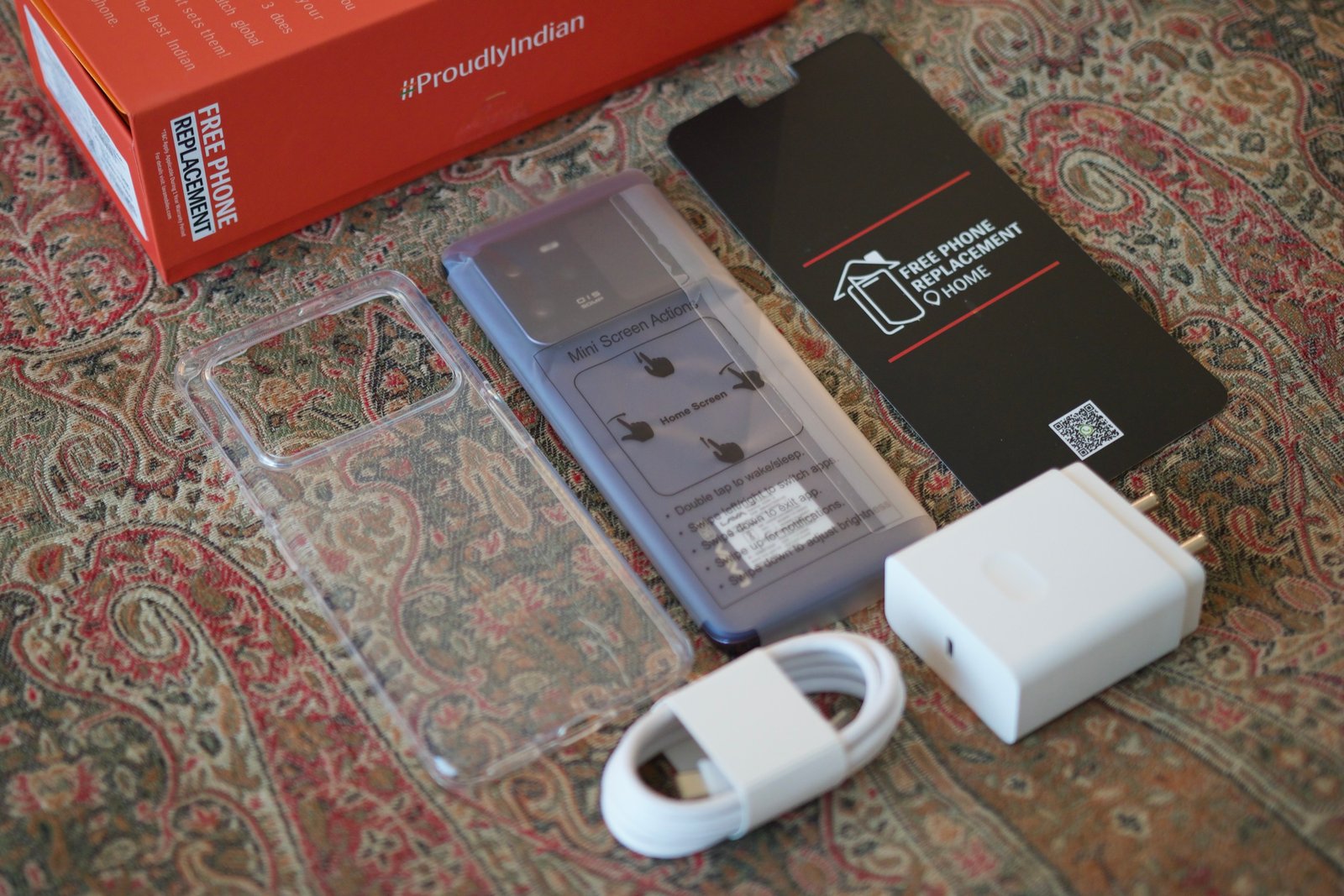 The Lava Agni 3 and everything included in the box, including a case and charging accessories.