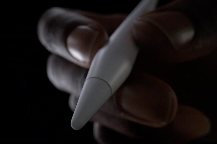 Close-up of tip of Apple Pencil Pro being held in a person's hand.