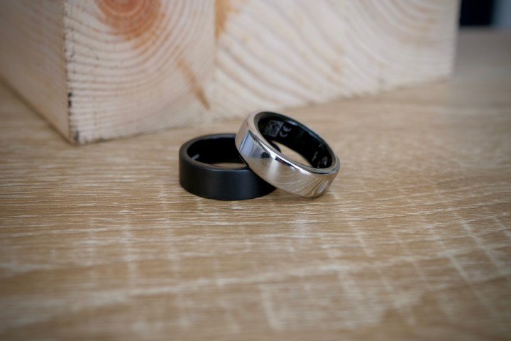 The Ultrahuman Ring Air and the Oura Ring, resting on a table.