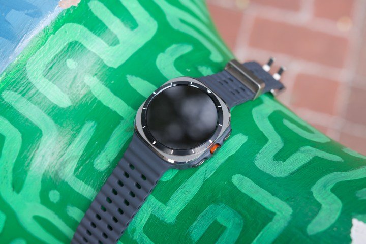 The Samsung Galaxy Watch Ultra laying on an green sculpture.