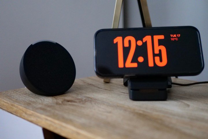 An Amazon Echo Dot next to an iPhone 16 Pro Max showing Standby mode.