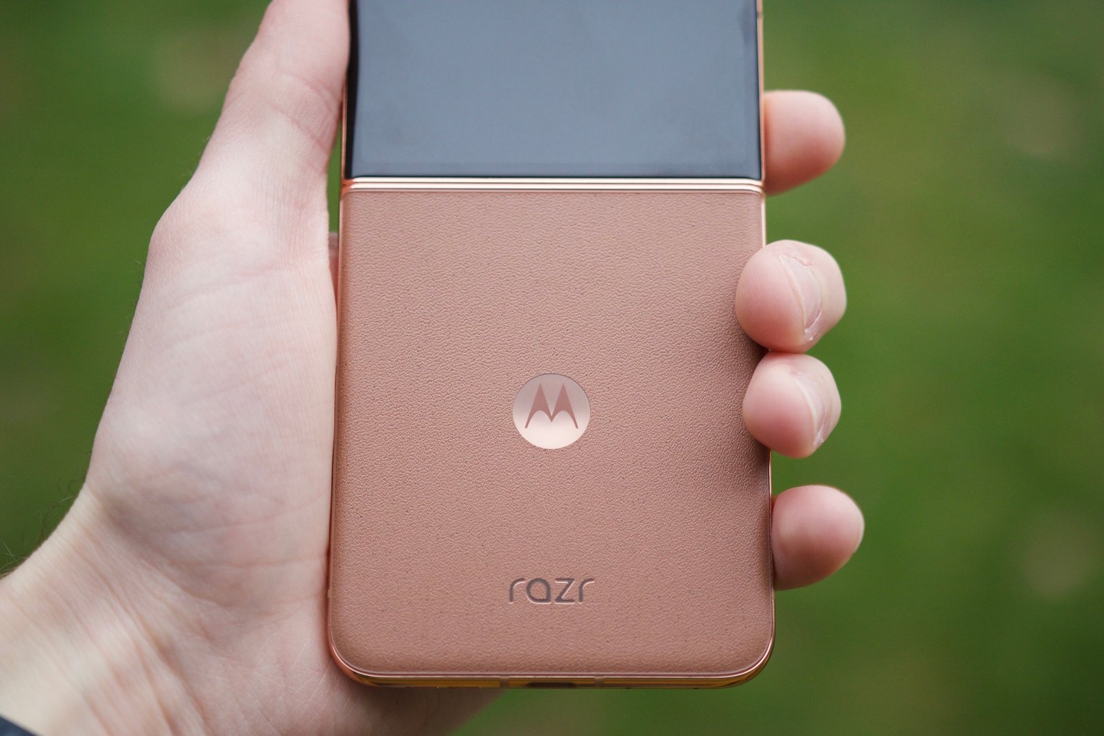 Someone holding the Mocha Mousse Motorola Razr Plus.