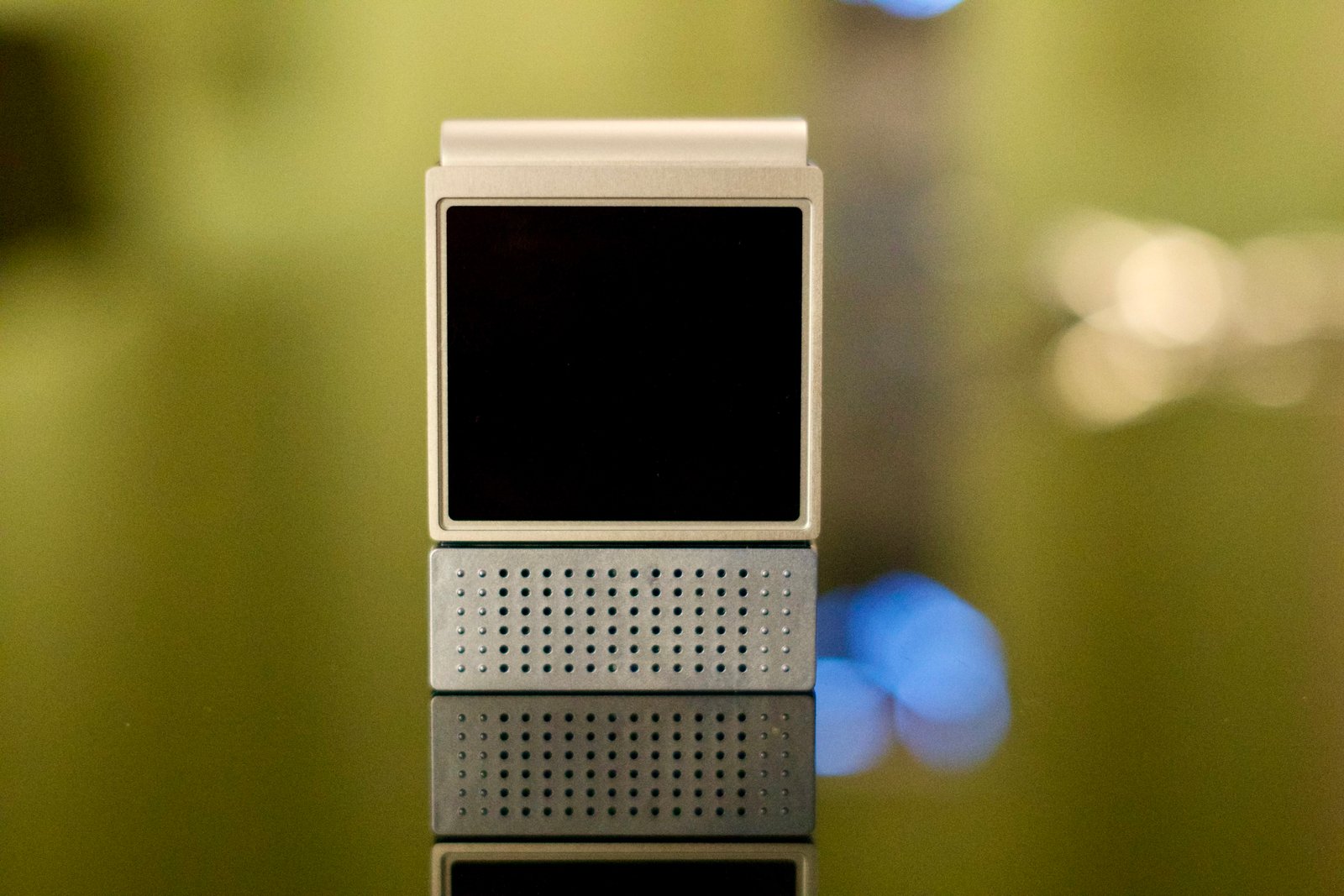 The Amazfit V1tal sitting on a table with its screen off.