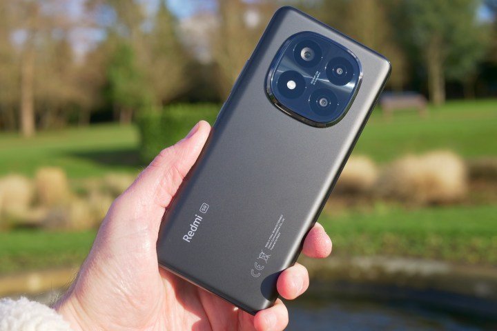 A person holding the Redmi Note 14 Pro Plus.