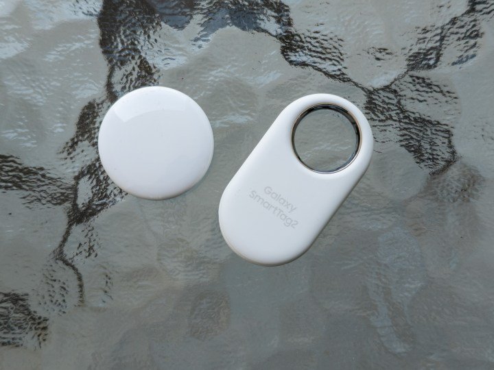 Apple AirTag and Samsung Galaxy Tag 2 next to each other on a table