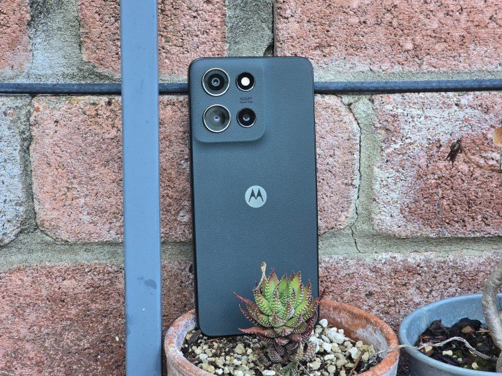 Moto G 2025 propped up behind a plant