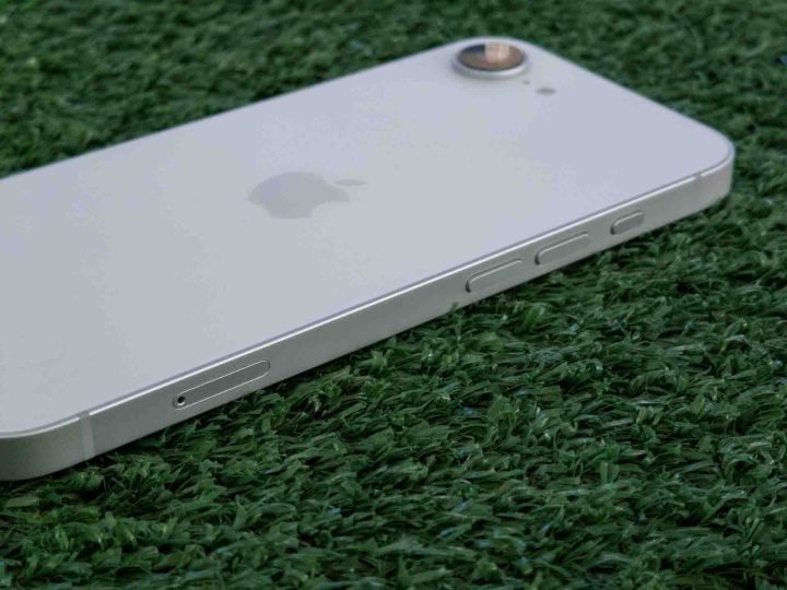 iPhone 16e on grass at an angle