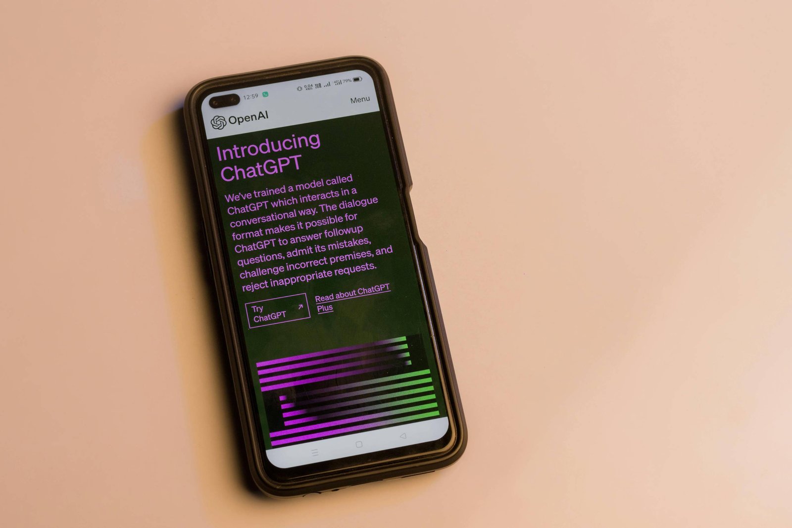 a phone displaying the ChatGPT homepage on a beige bbackground.