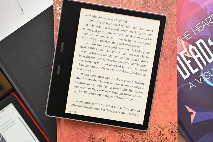 The Kindle Oasis on top of some books.