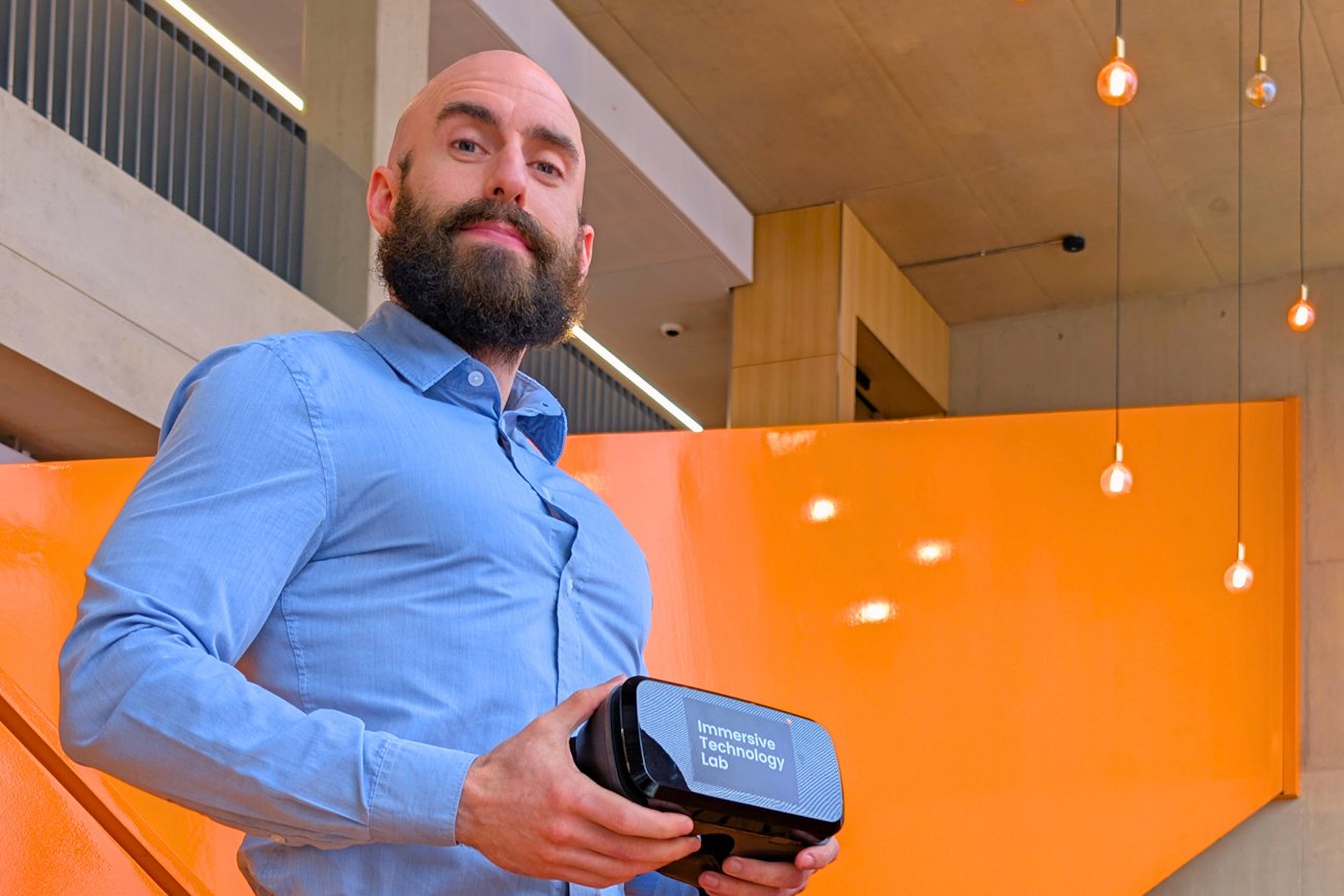 Person holding a VR kit for speech anxiety training.