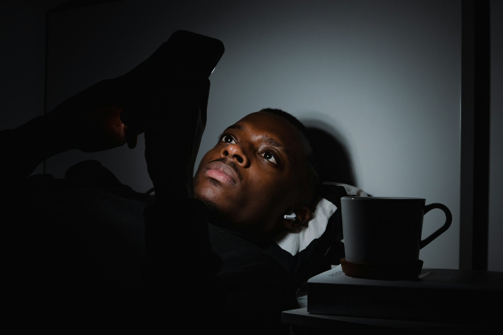 Person looking at a phone while lying down.