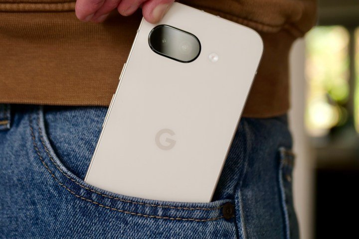 A person taking the Google Pixel 9a out of a pocket.