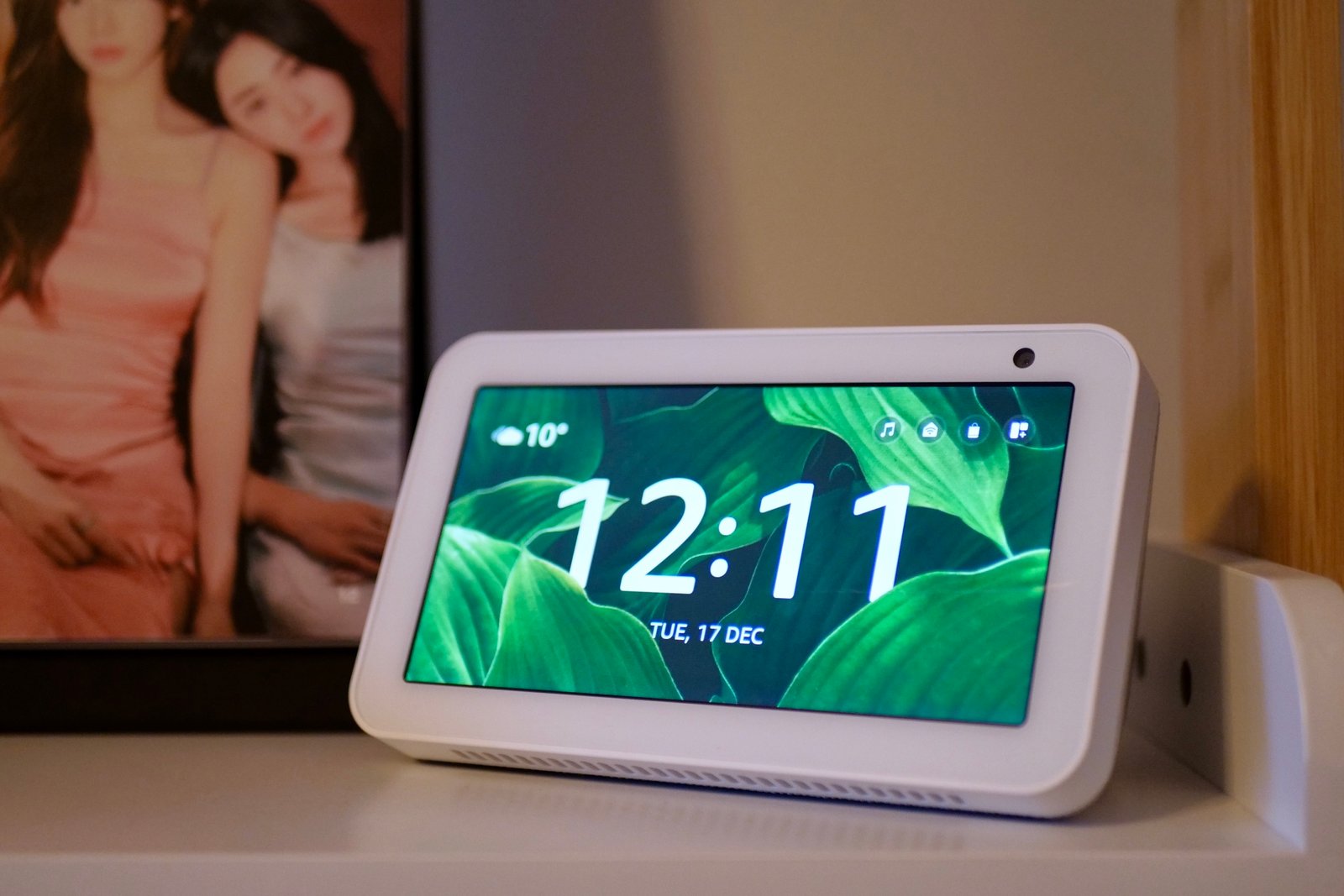 An Amazon Echo Show 5 on a shelf.