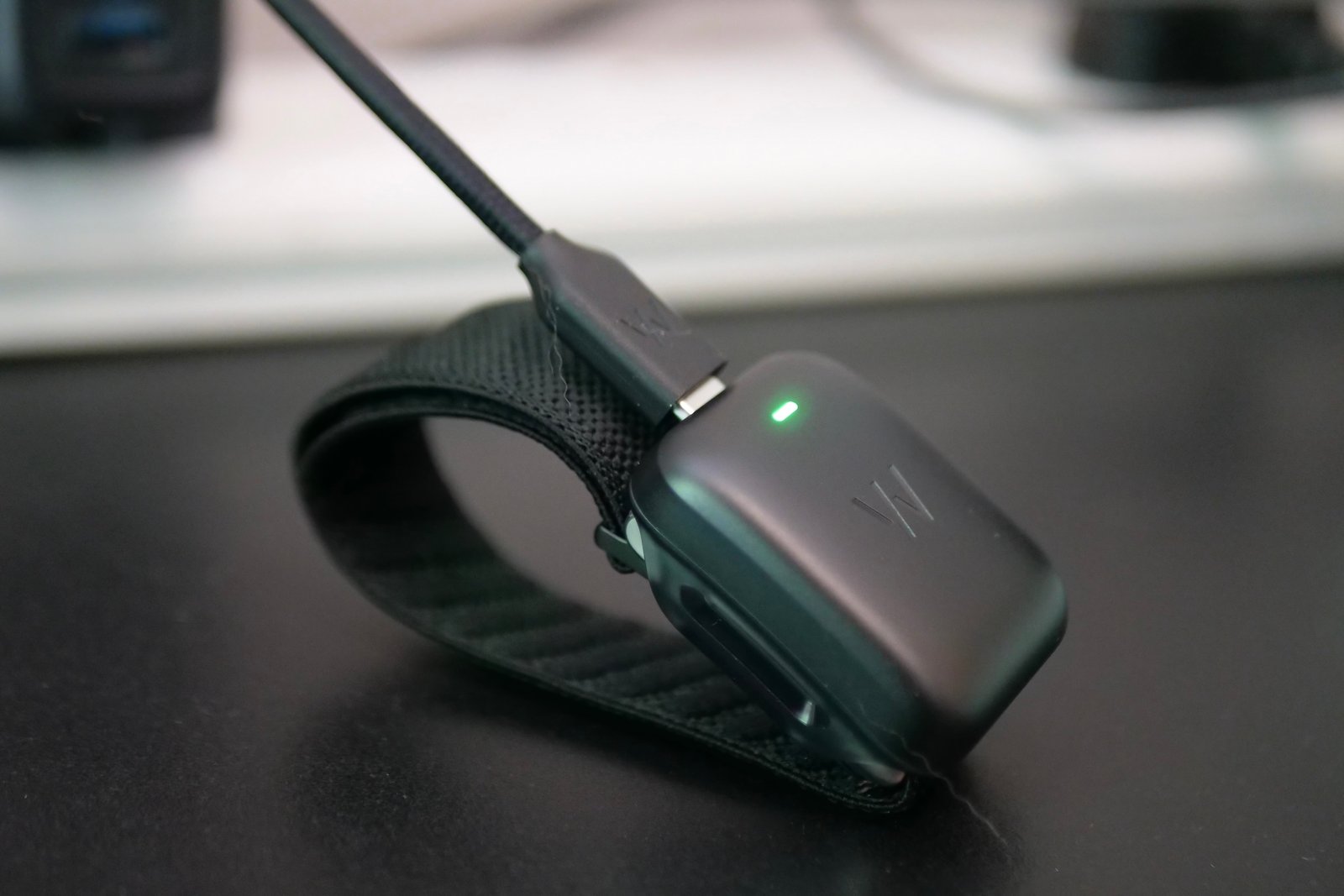 The Whoop 5.0 on charge.