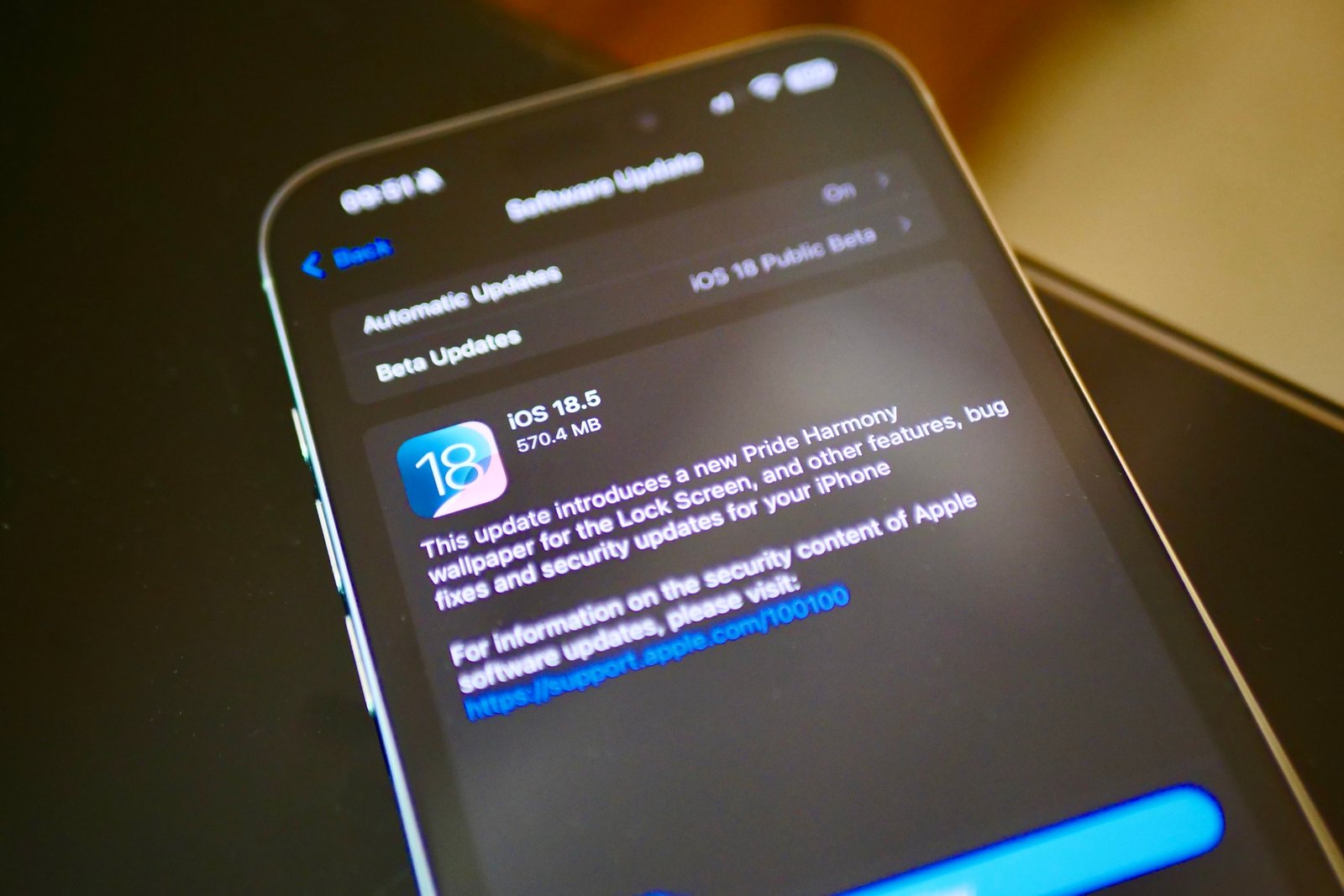 The iOS 18.5 update waiting on an iPhone 16 Pro Max.