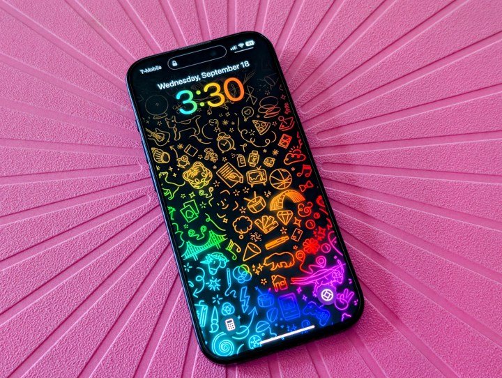 iPhone 15 Pro with iOS 18 lock screen.