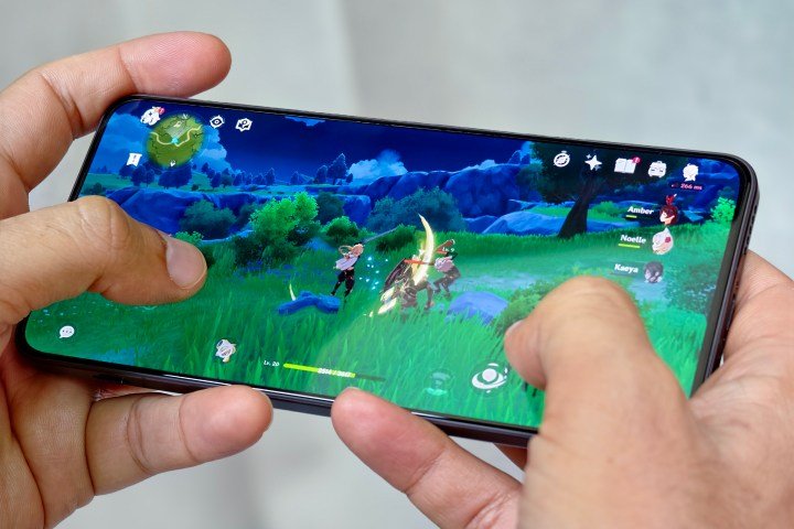 Someone playing Genshin Impact on a phone