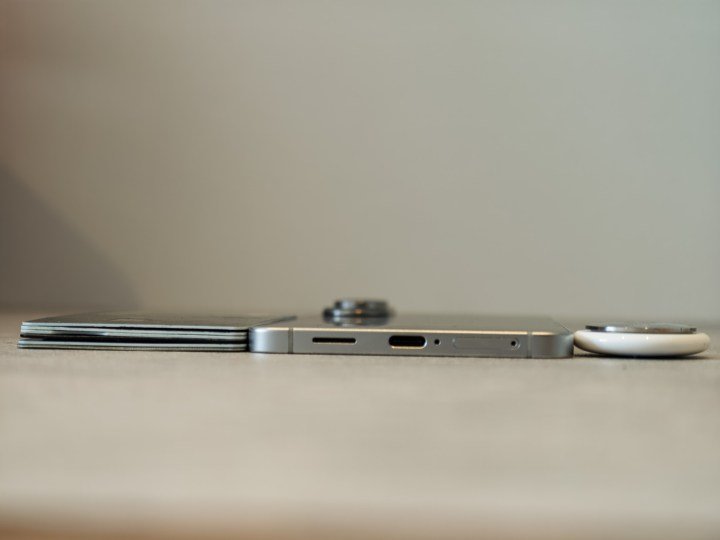Galaxy S25 Edge next to six credit cards and an airtag