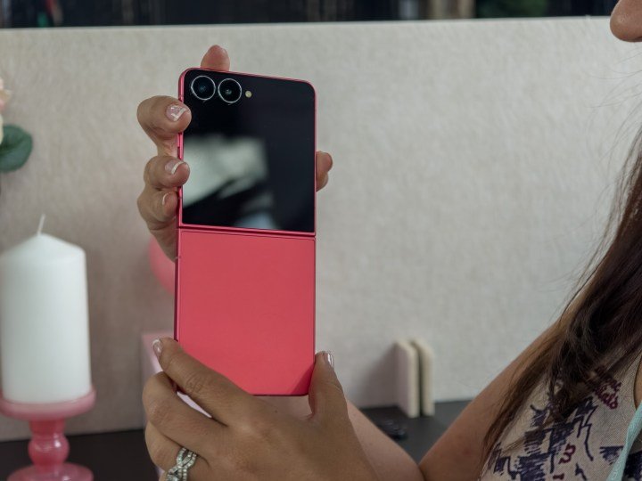 Galaxy Z Flip 7 in coralred held in a woman's hands