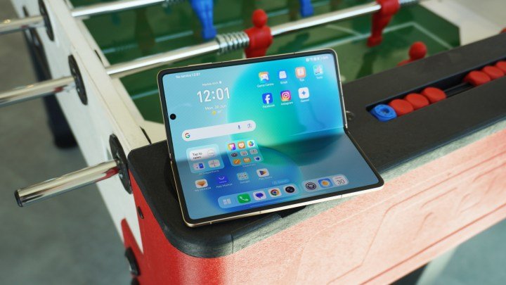 The Magic V5 screen part unfolded, resting on a foosball table