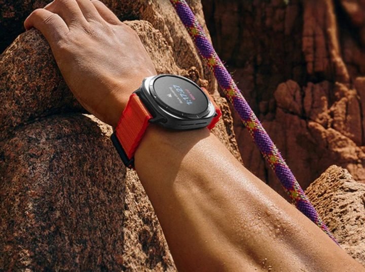 A man climbs a mountain with a Samsung Galaxy Watch Ultra 2025.