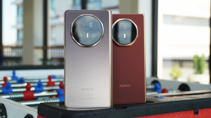 The Magic V5 and Magic V3 foldable phones standing on a foosball table